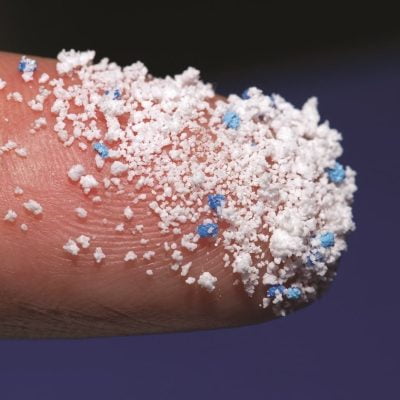 Small Plastic pellets on the finger. Micro plastic air pollution