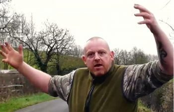 Aggressive foxhunt worker of some description who rants and raves at a female foxhunt saboteur using the F word and intimidating her although she stands her ground bravely.